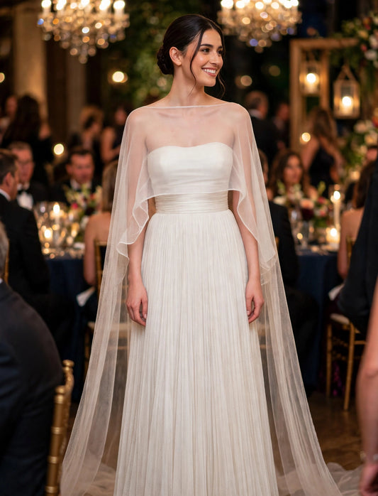 Elegant White Pleated Gown With Sheer Cape Overlay